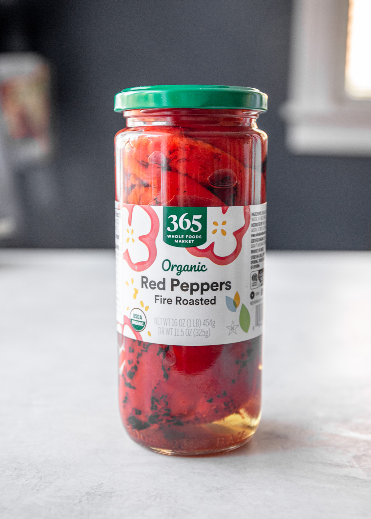 a jar of roasted red peppers on a white countertop