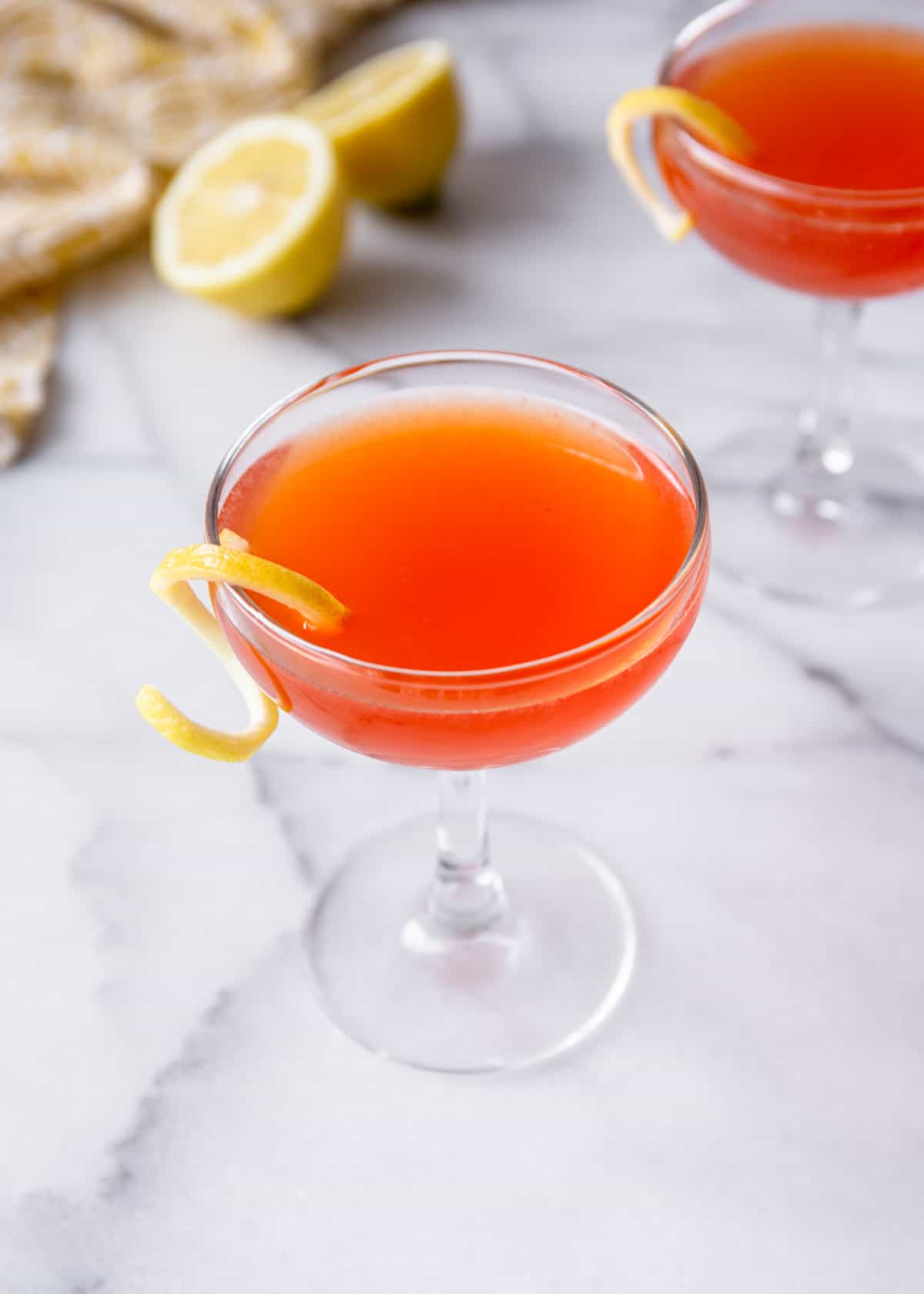 orange cocktails in glasses on a marble countertop