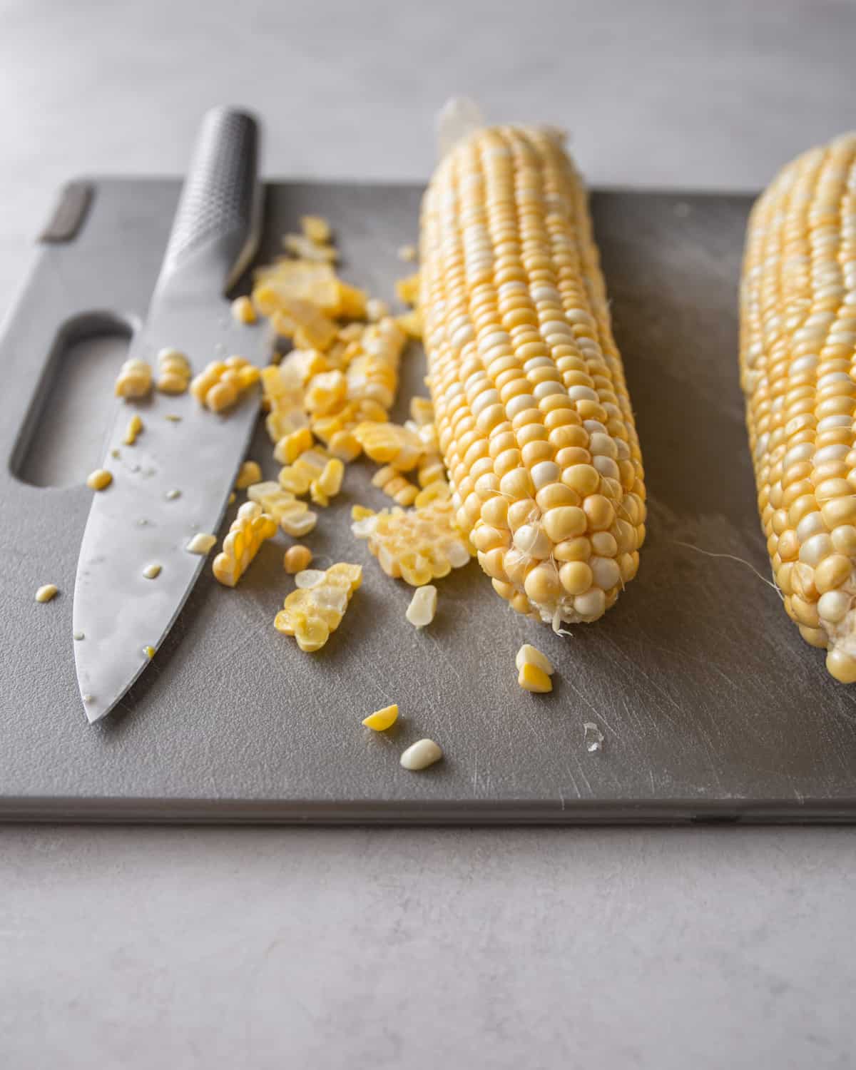 cutting corn kernels off the cob