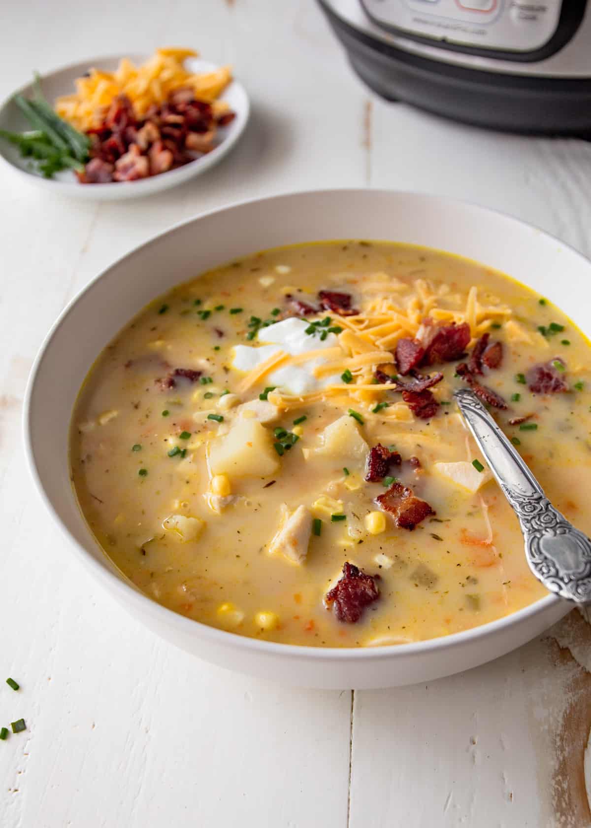 a bowl of instant pot chicken chowder on a white table