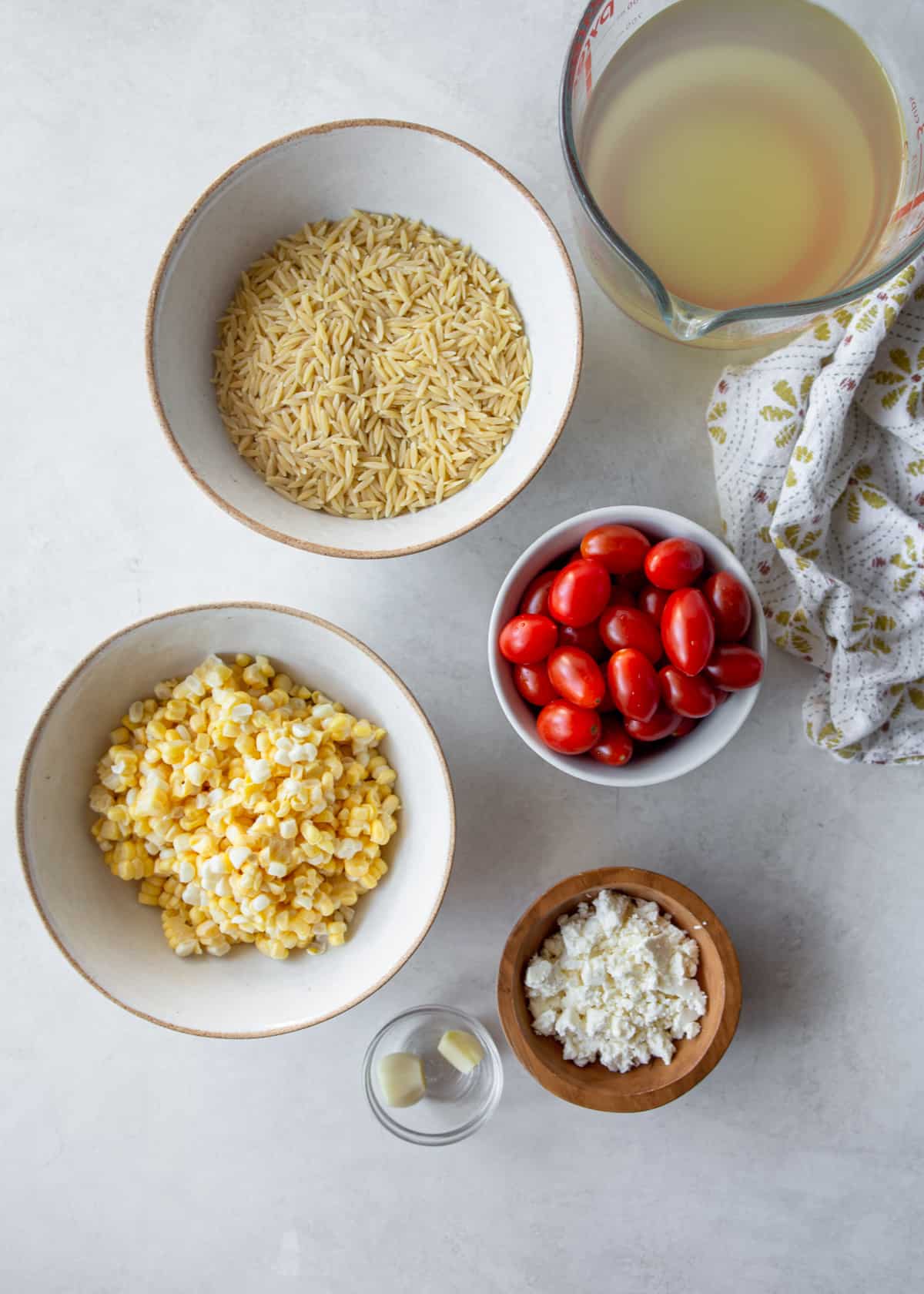 ingredients for one pot orzo with feta on a gray countertop