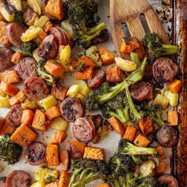 roasted vegetables and sausage on a sheet pan