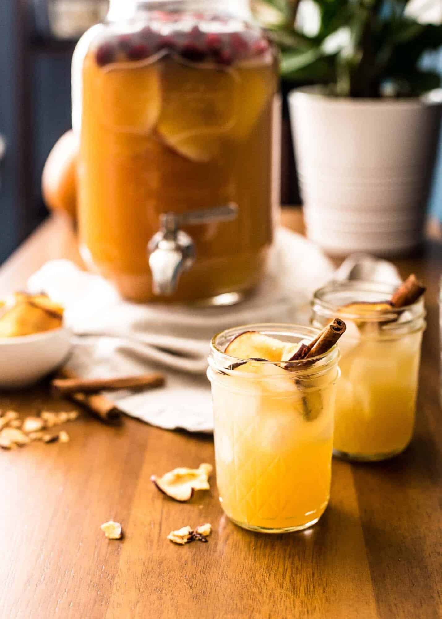 apple cider punch in small mason jars on a wooden table