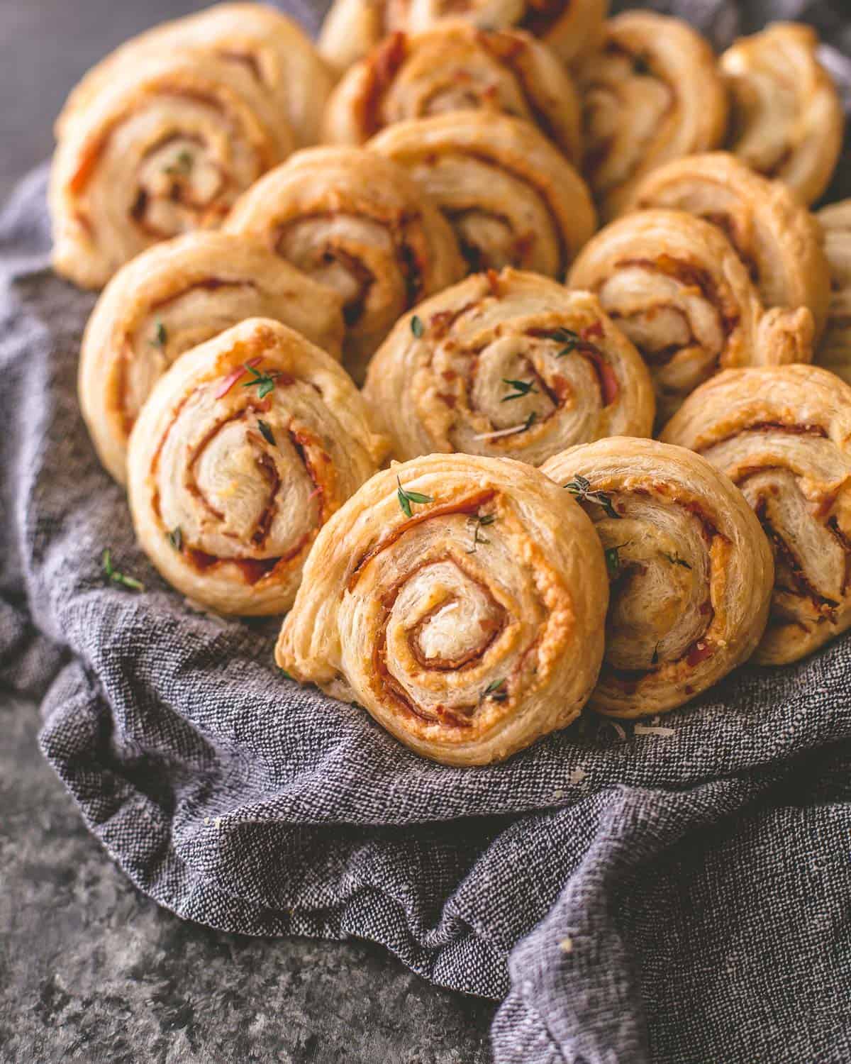 cheese pinwheels in a blue towel lined basket