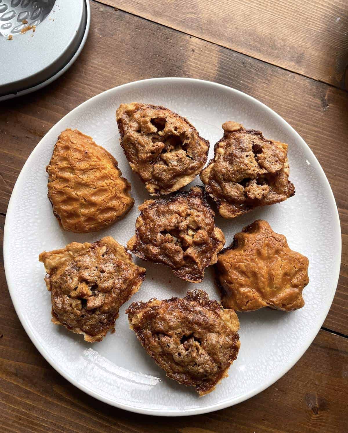 overhead view of pecan tarts on a white plate