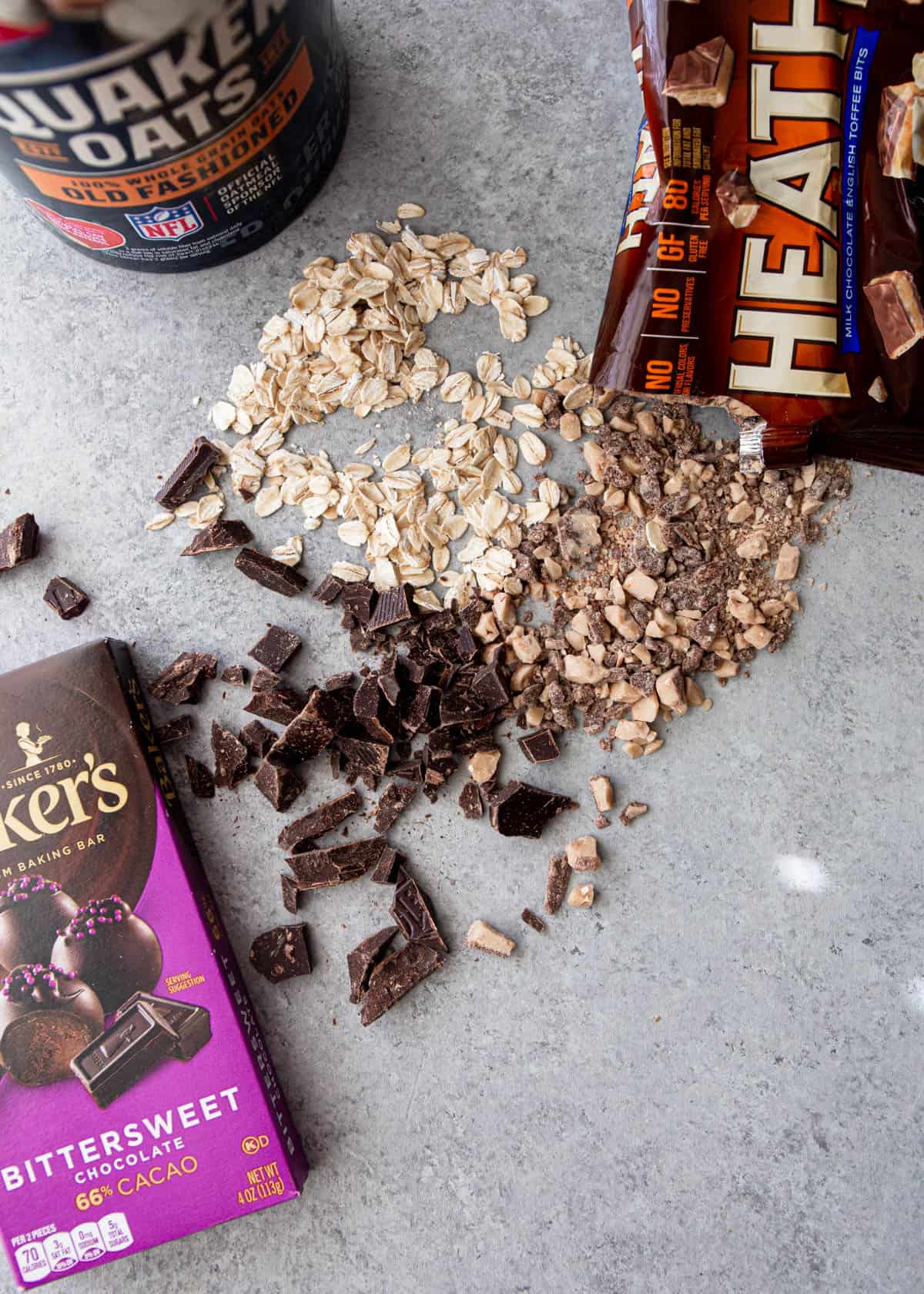 chocolate, oats, and toffee bits on a grey countertop