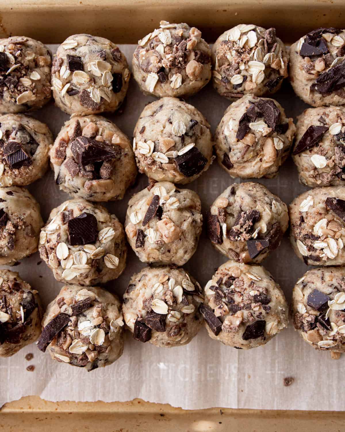 chocolate oatmeal cookie balls on a parchment lined sheet pan