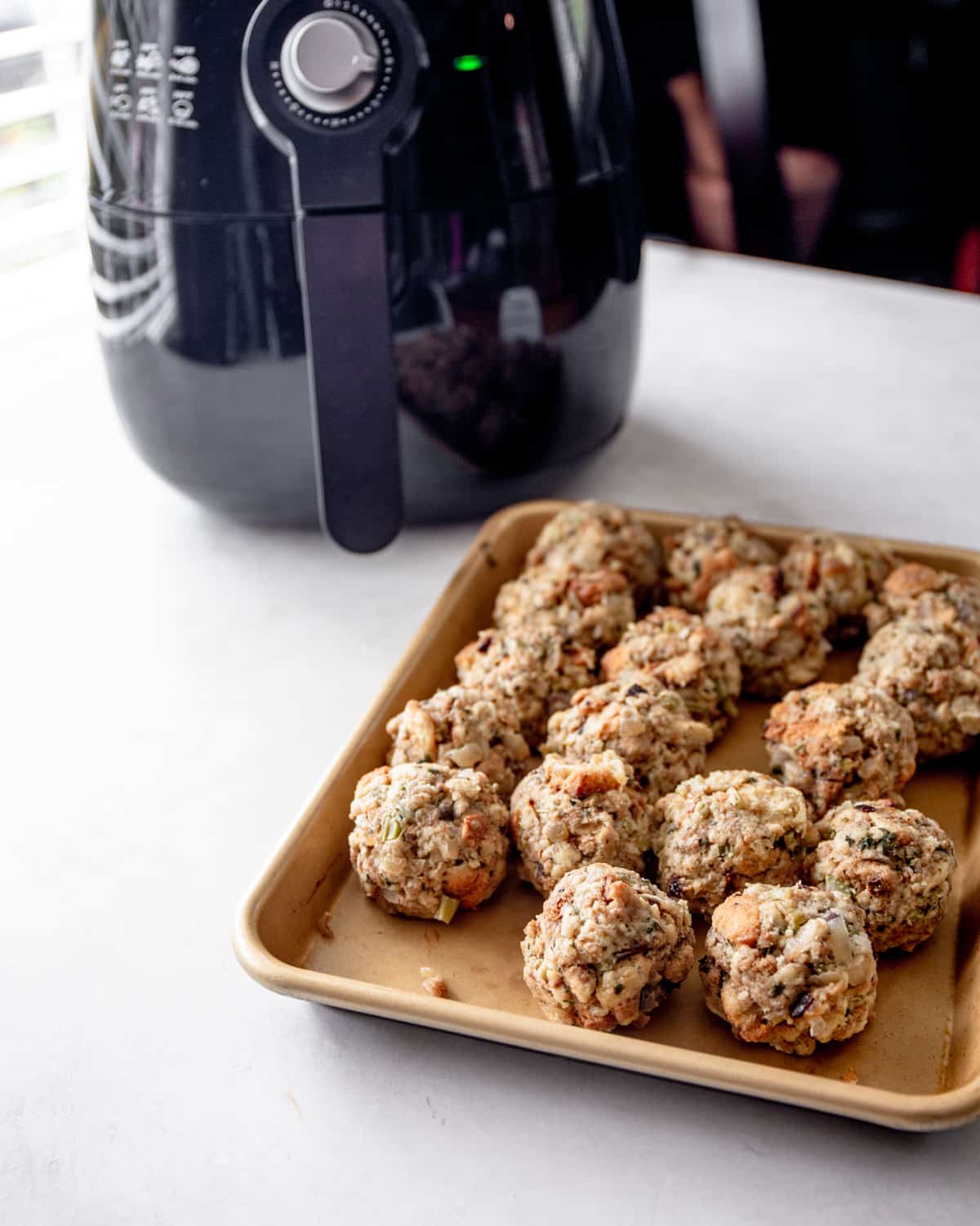 uncooked stuffing balls on an air fryer tray