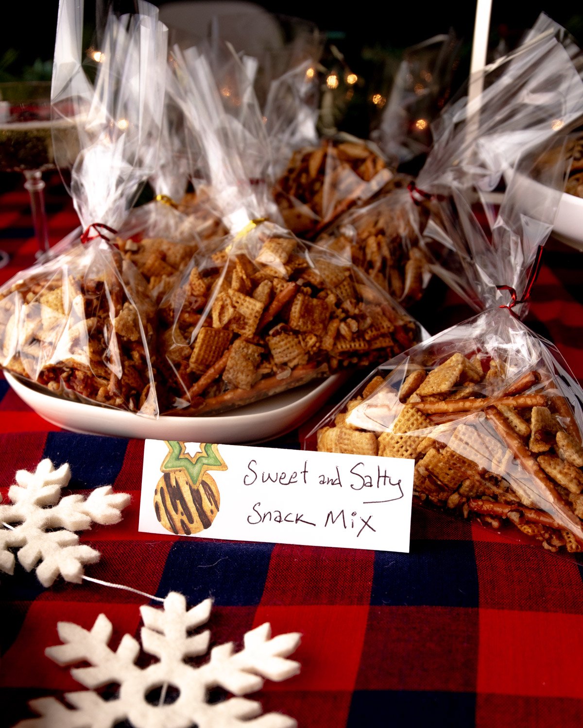 snack mix in small bags on a white plate with a label