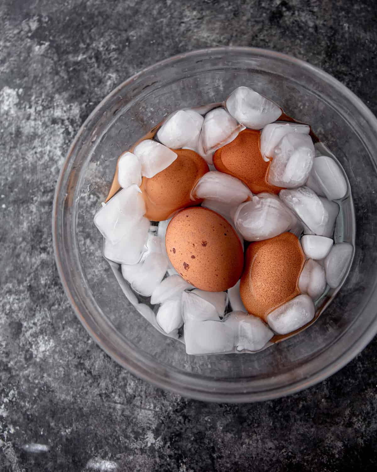 soft boiled eggs in a clear glass bowl with ice