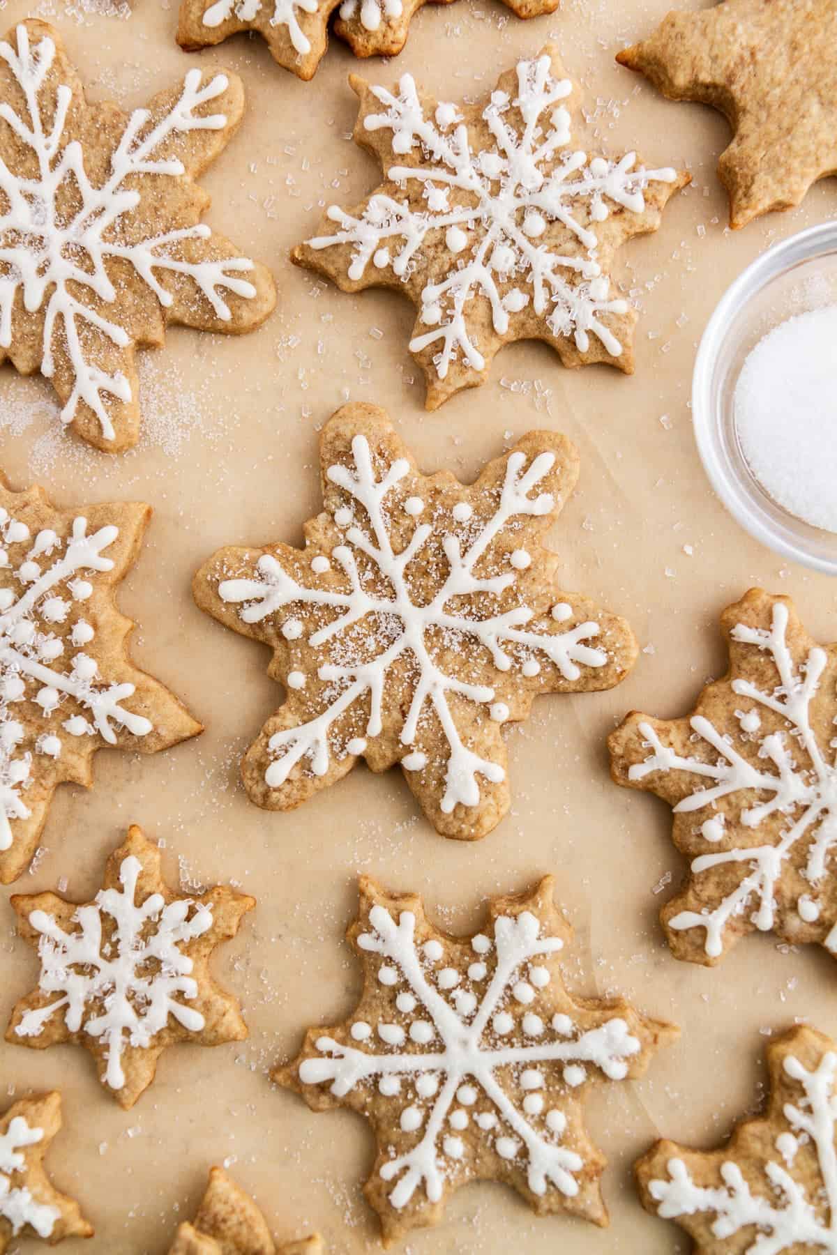 snowflake cookies on a parchment lined sheet pan