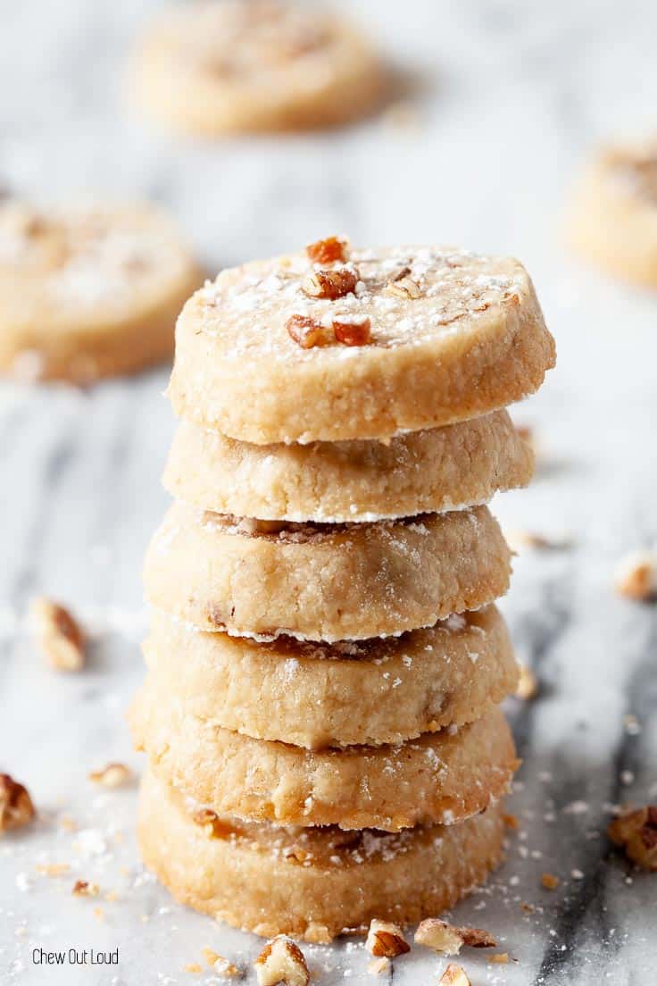 pecan sandy cookies stacked on a plate
