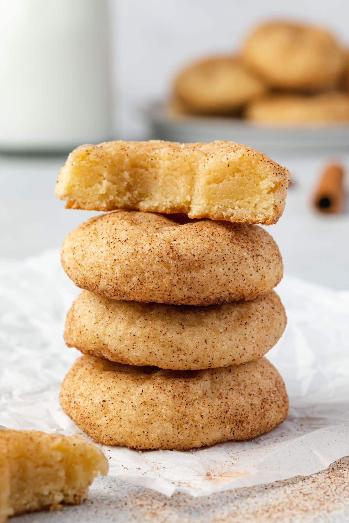 snickerdoodle cookies stacked on parchment paper