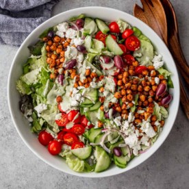 overhead image of green goddess salad in a white bowl