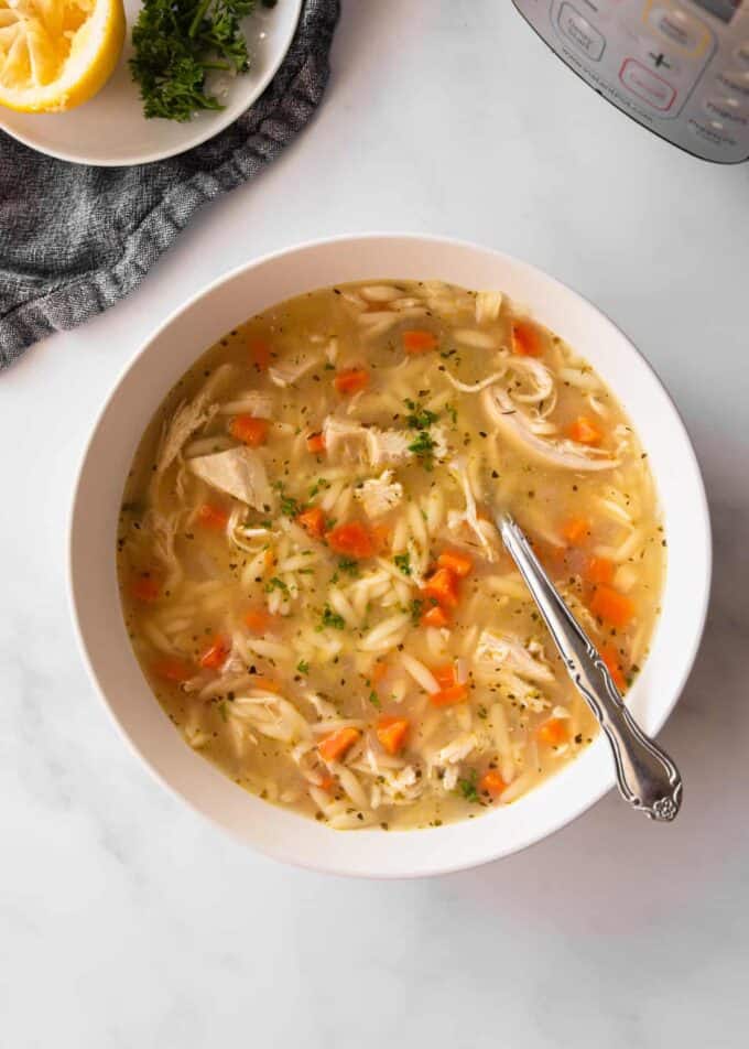 chicken orzo soup in a white bowl