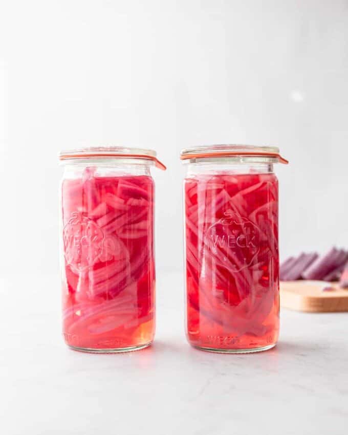 pickled onions in a white glass jar