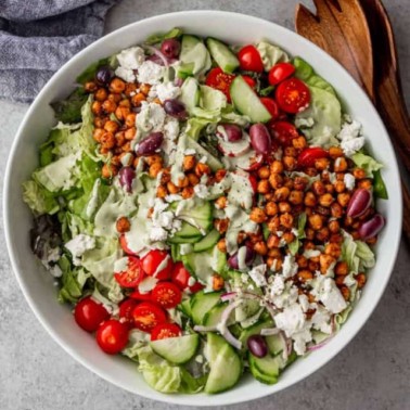 greek salad with chickpeas in a white bowl