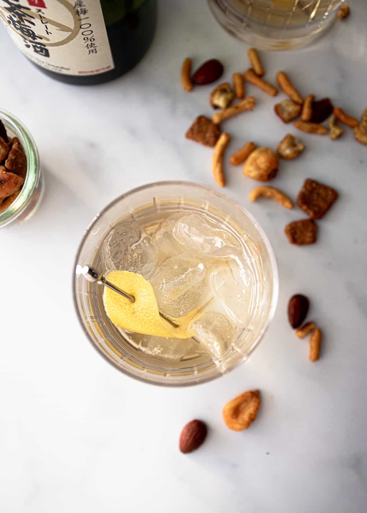 an overhead image of a cocktail in a glass on a grey countertop