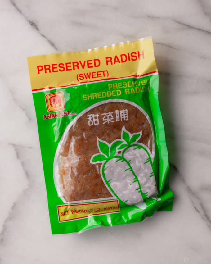 a green and yellow package of preserved radishes