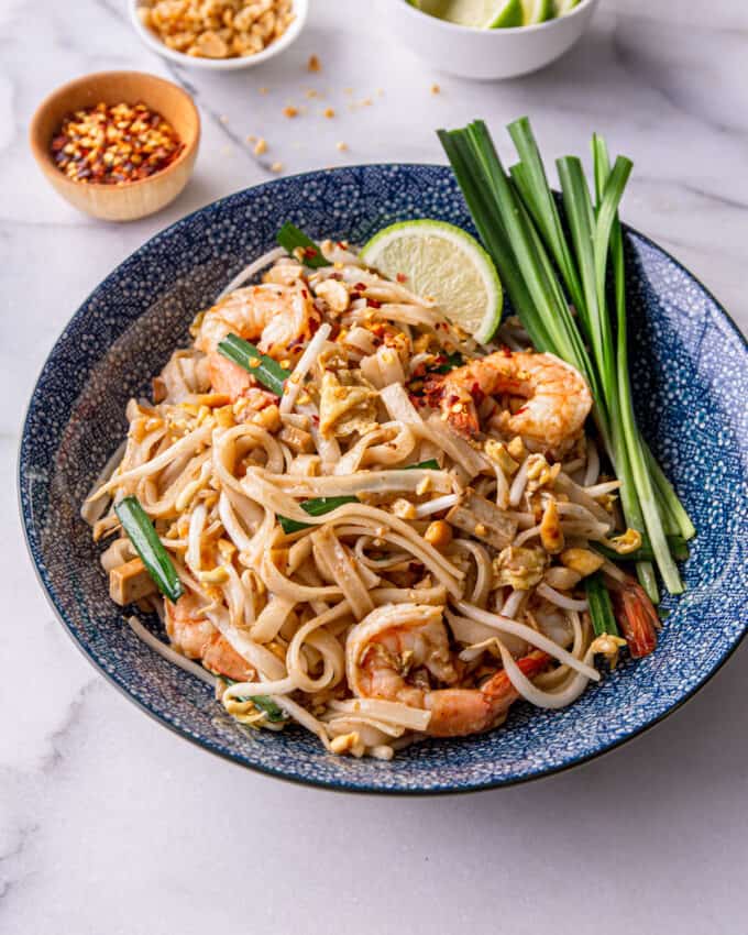 pad thai with shrimp in a blue floral bowl
