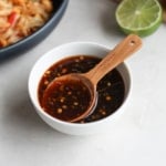 sauce and wooden spoon in a small white bowl