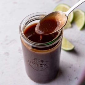 weck jar of dark red sauce with a spoon