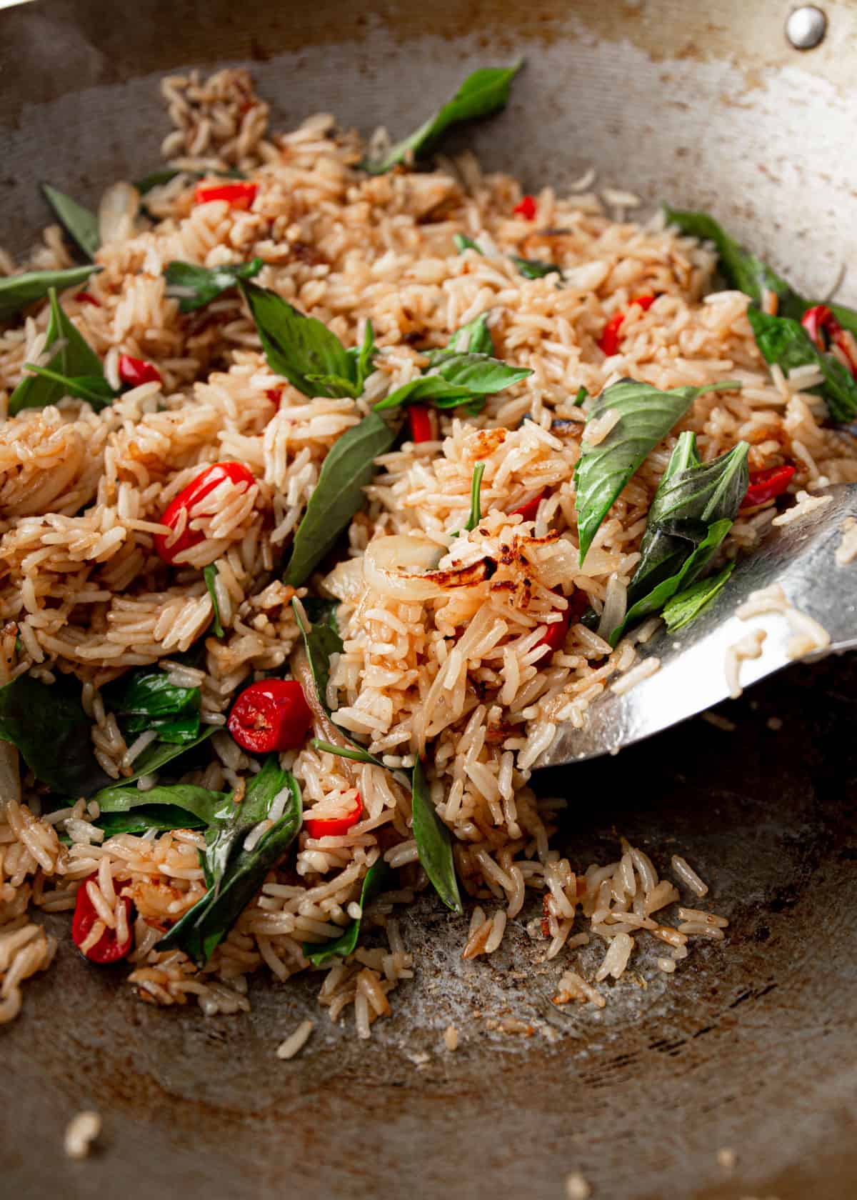 stirring fried rice in a wok