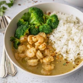 shrimp and yellow curry in a white bowl