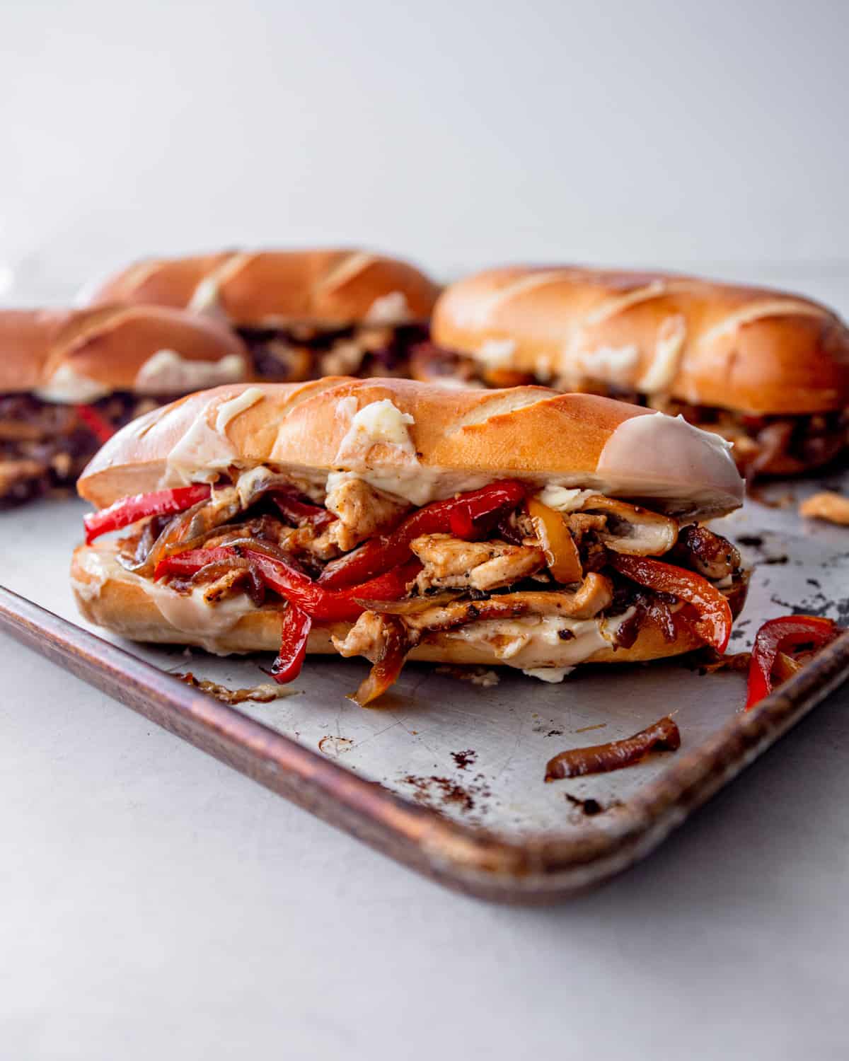 chicken philly sandwiches on a sheet pan