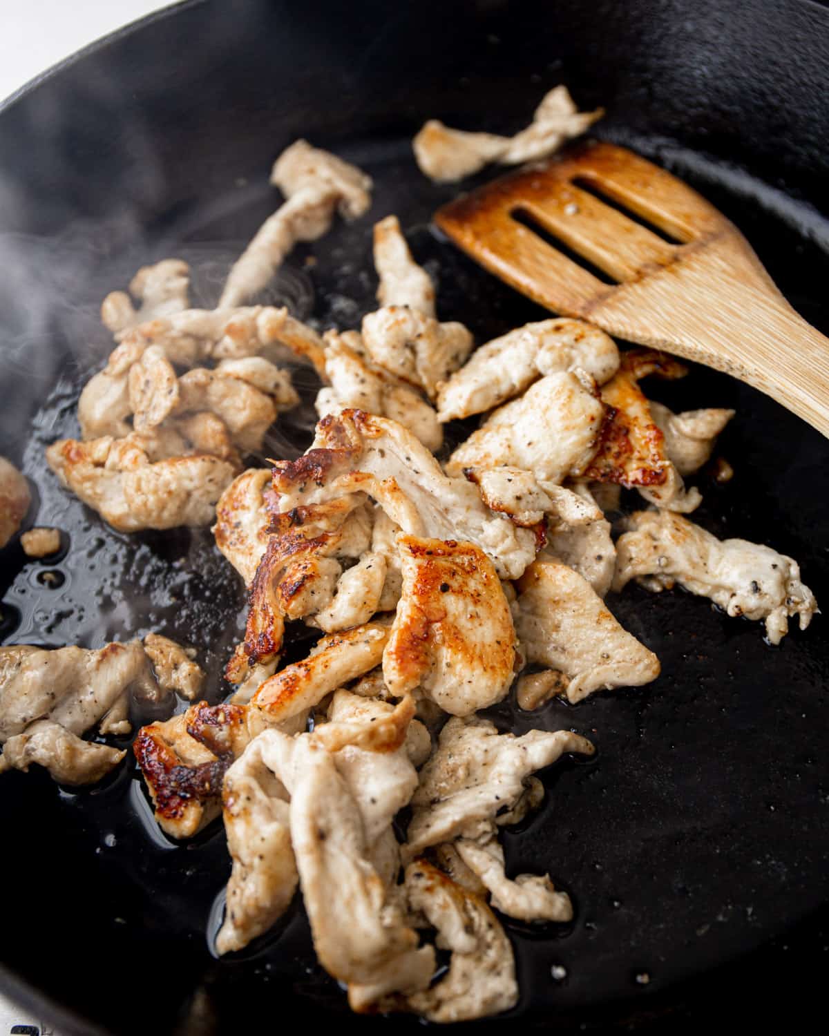 cooking chicken strips in a skillet