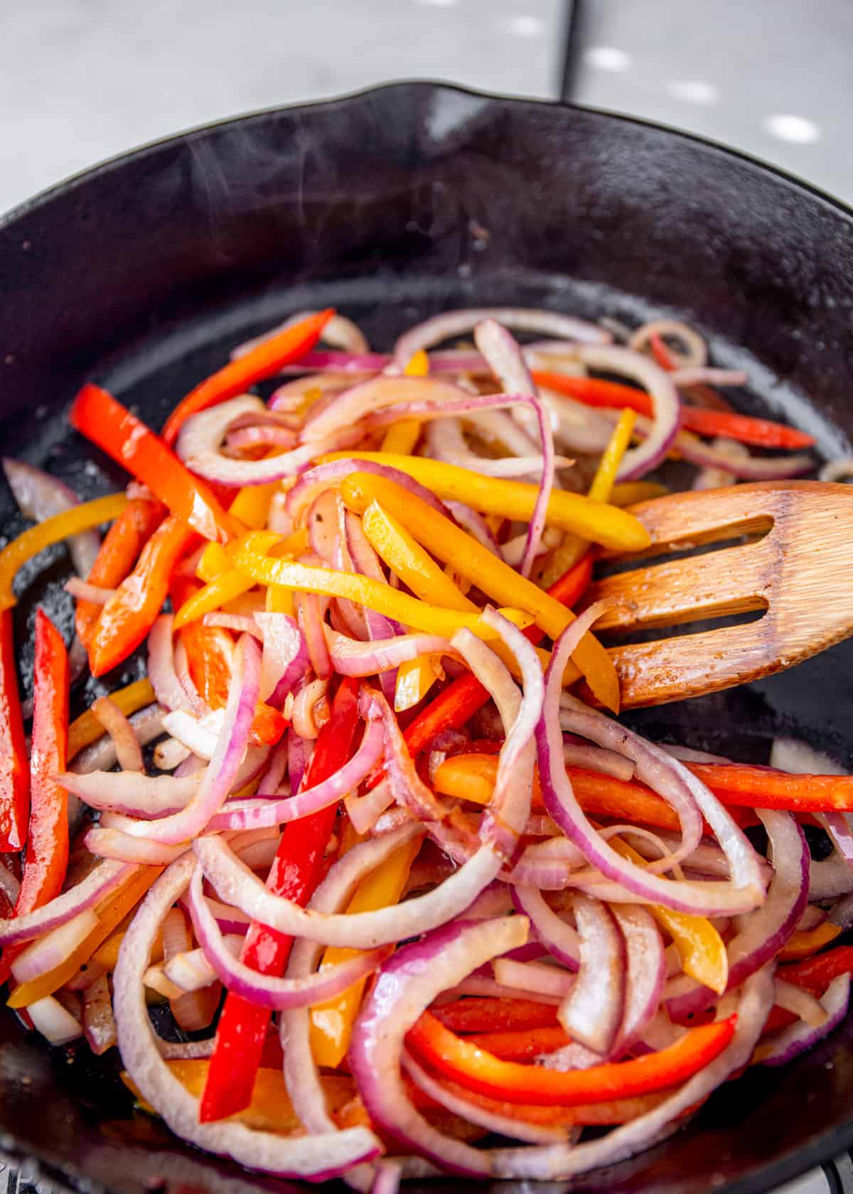 cooking peppers and onions in a skillet