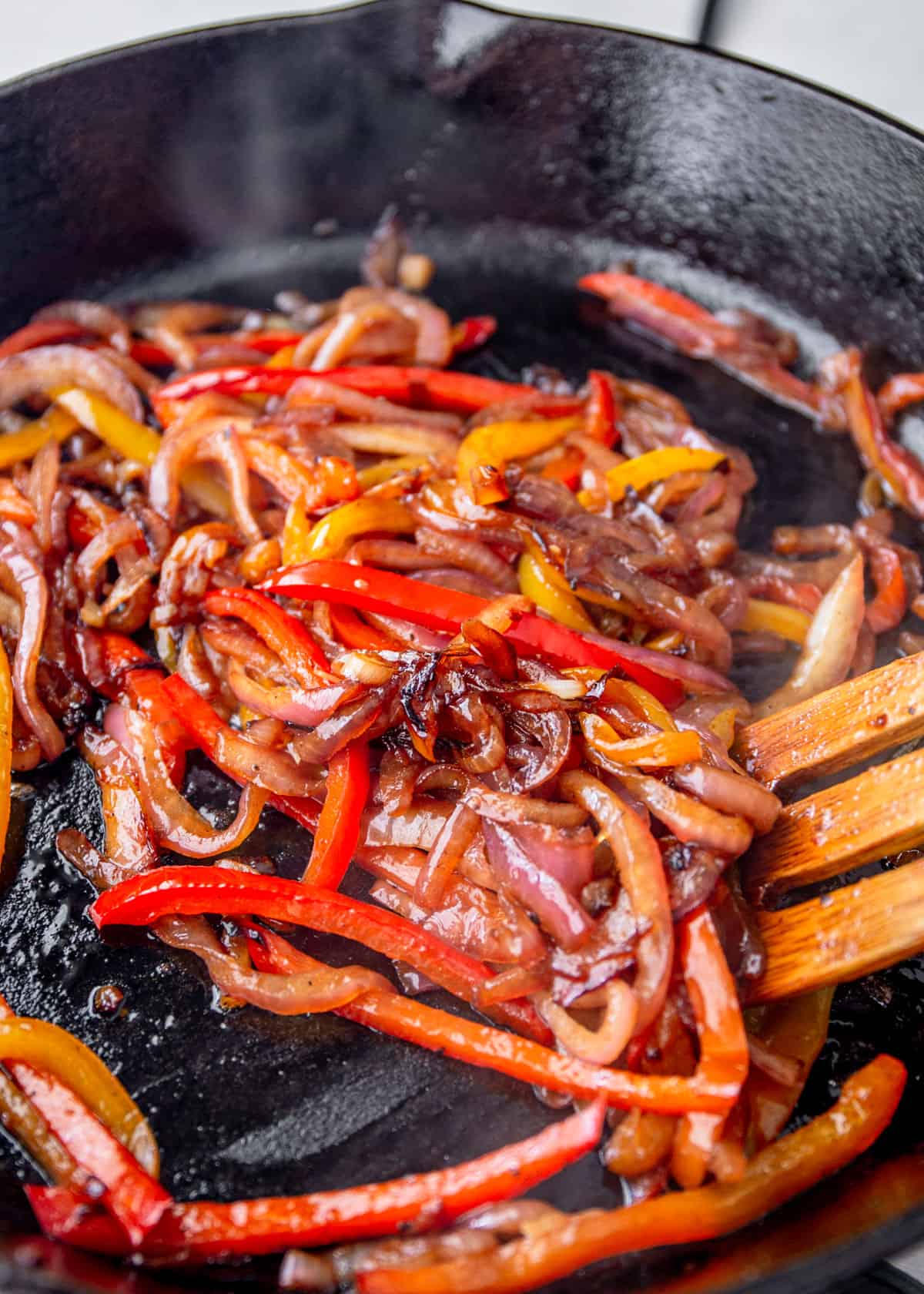 cooked peppers and onions in a skillet