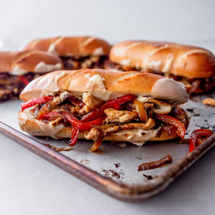 4 chicken philly sandwiches on a sheet pan