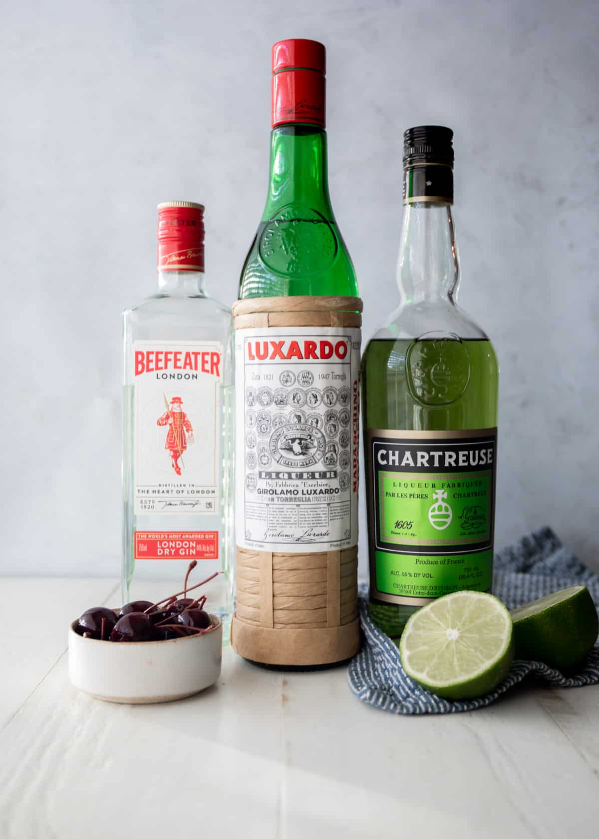 ingredients for last word cocktail on a grey countertop