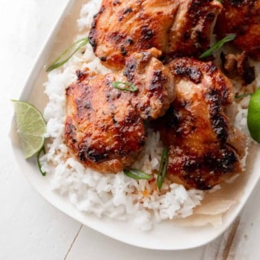 lemongrass chicken and rice on a white tray