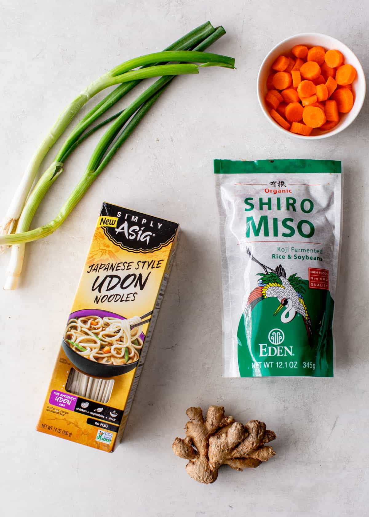 overhead image of ingredients for miso vegetable soup on a grey countertop