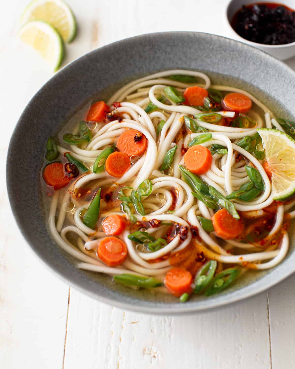 overhead image of soup with noodles in a grey bowl