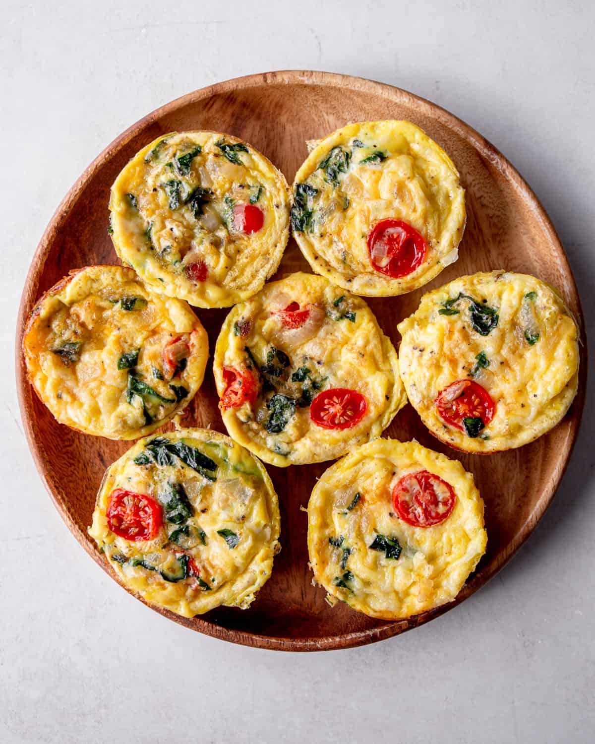 individual frittatas on a wooden tray