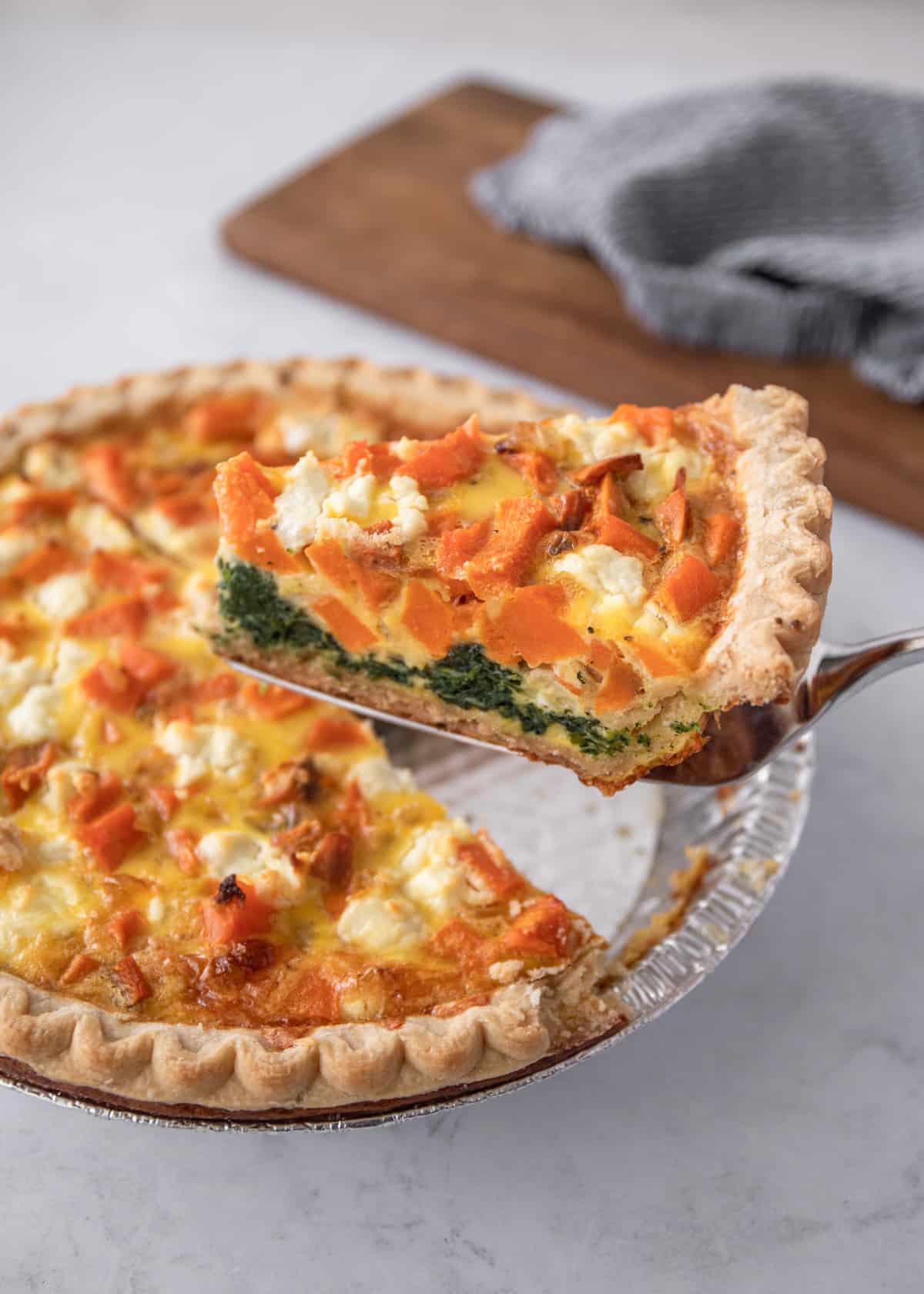 removing a slice from a quiche with a pie server