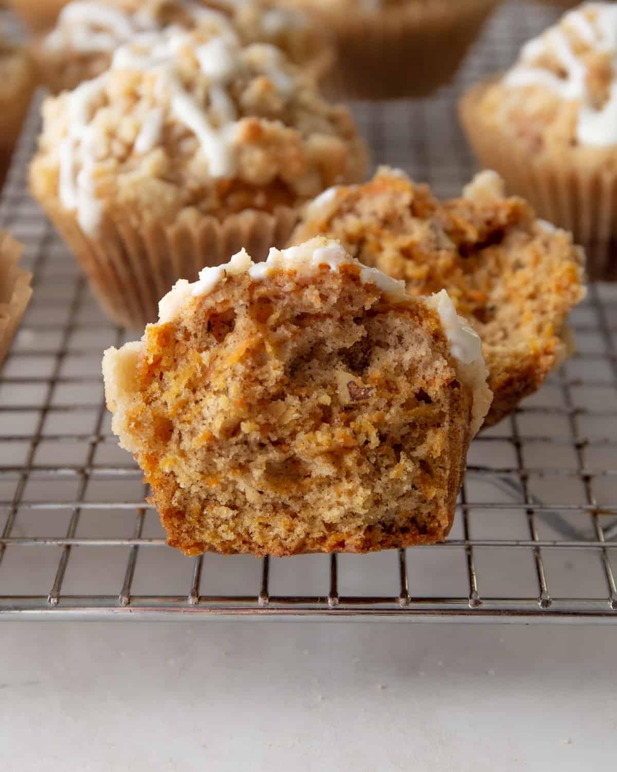 half of a carrot cake muffin on a cooling rack