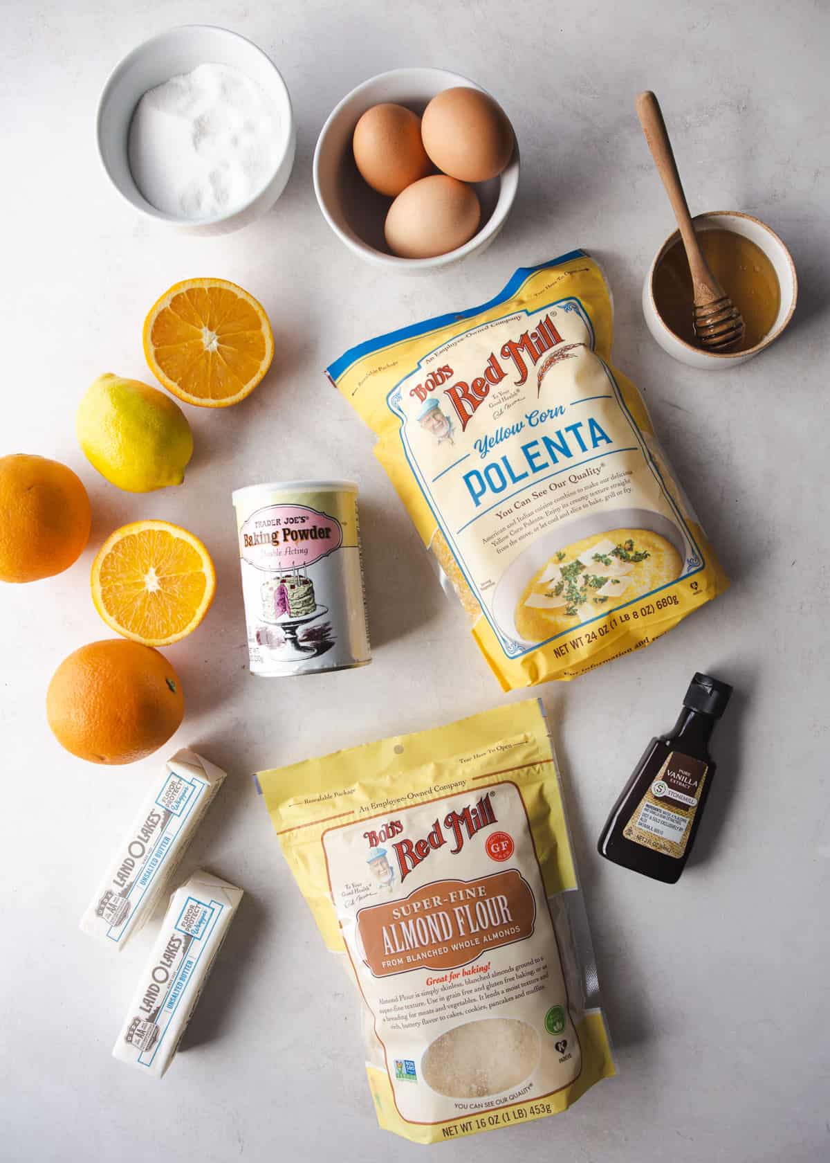 ingredients for honey citrus polenta cake on a white countertop