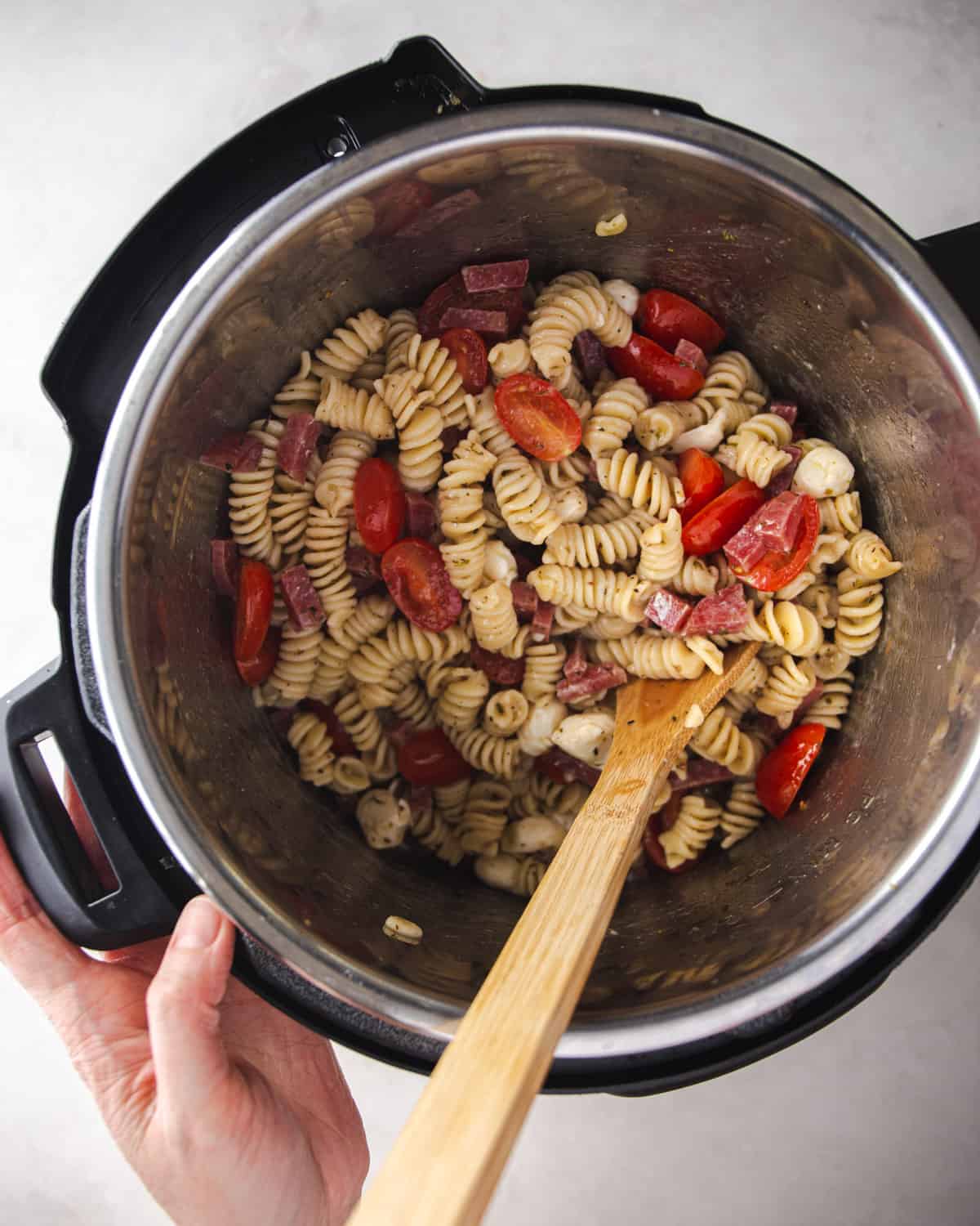 overhead image of stirring pasta salad in an instant pot