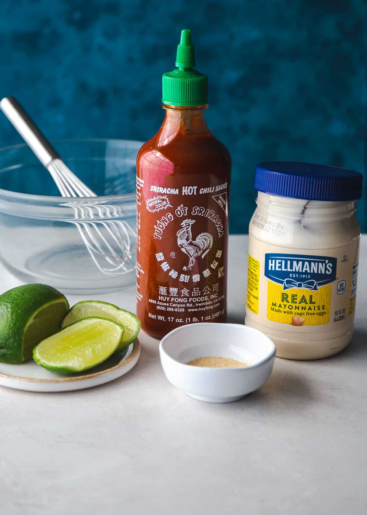 ingredients for sriracha mayo sauce on a grey countertop