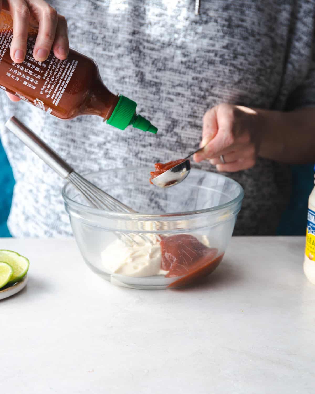 adding ingredients to a clear glass mixing bowl