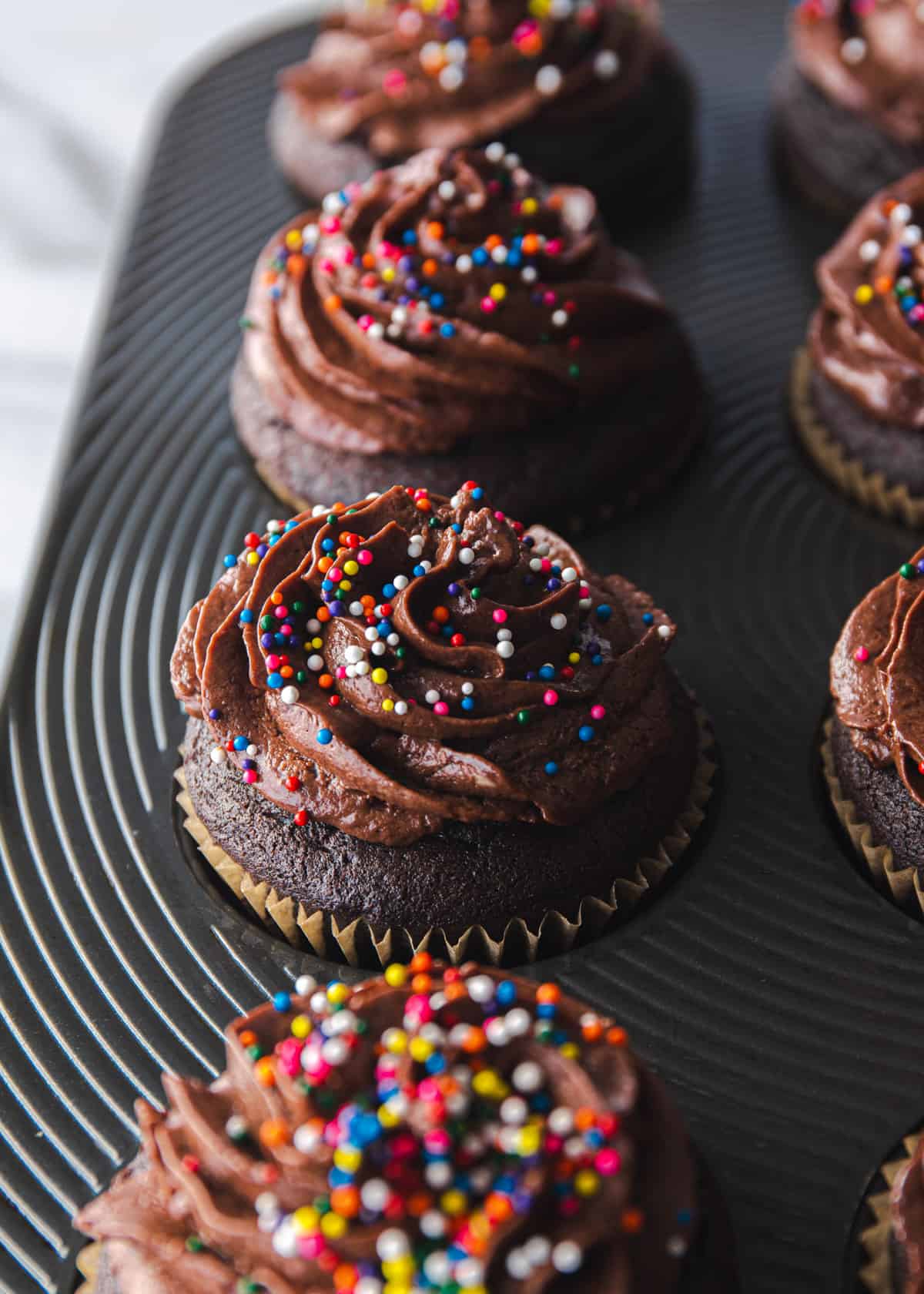 close up image of chocolate cupcakes in a muffin tin