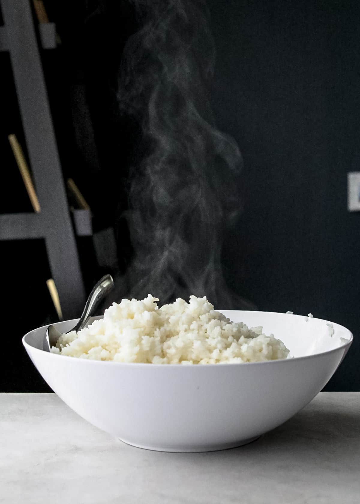 cooked rice cooling in a white bowl
