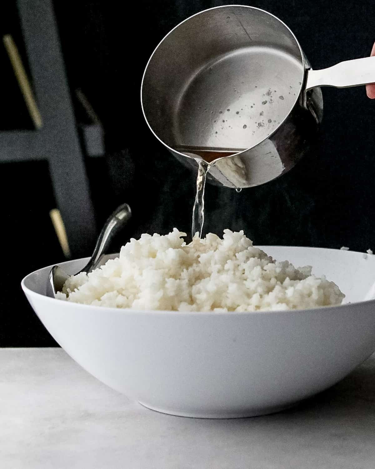 seasoning rice in a white bowl