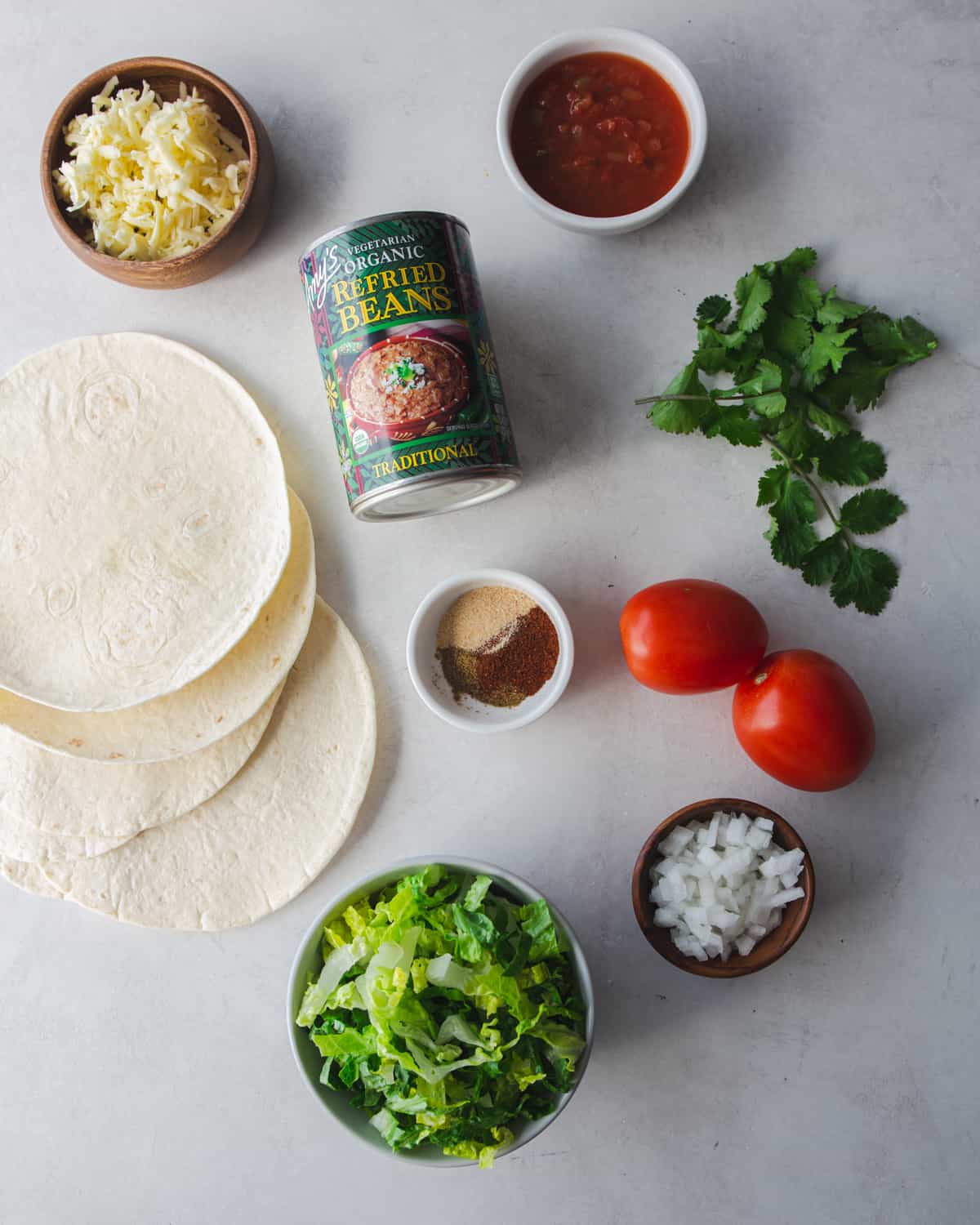 ingredients for vegetarian tostadas on a grey countertop