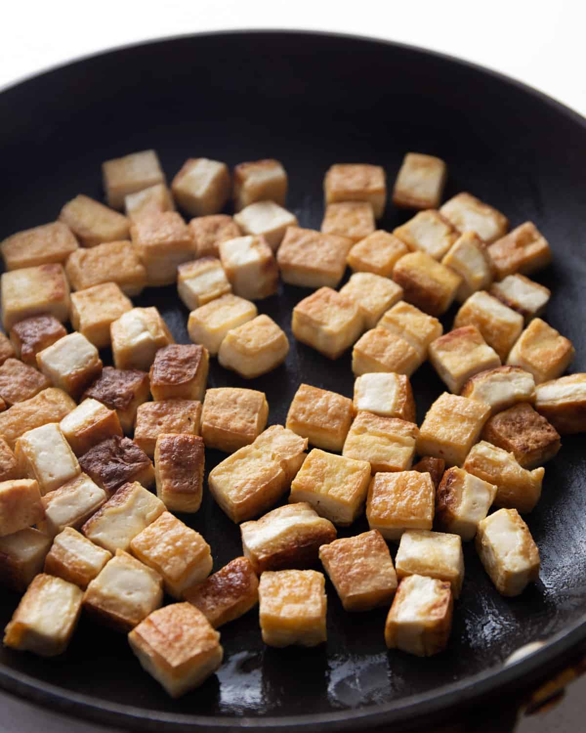 cooking tofu in a skillet
