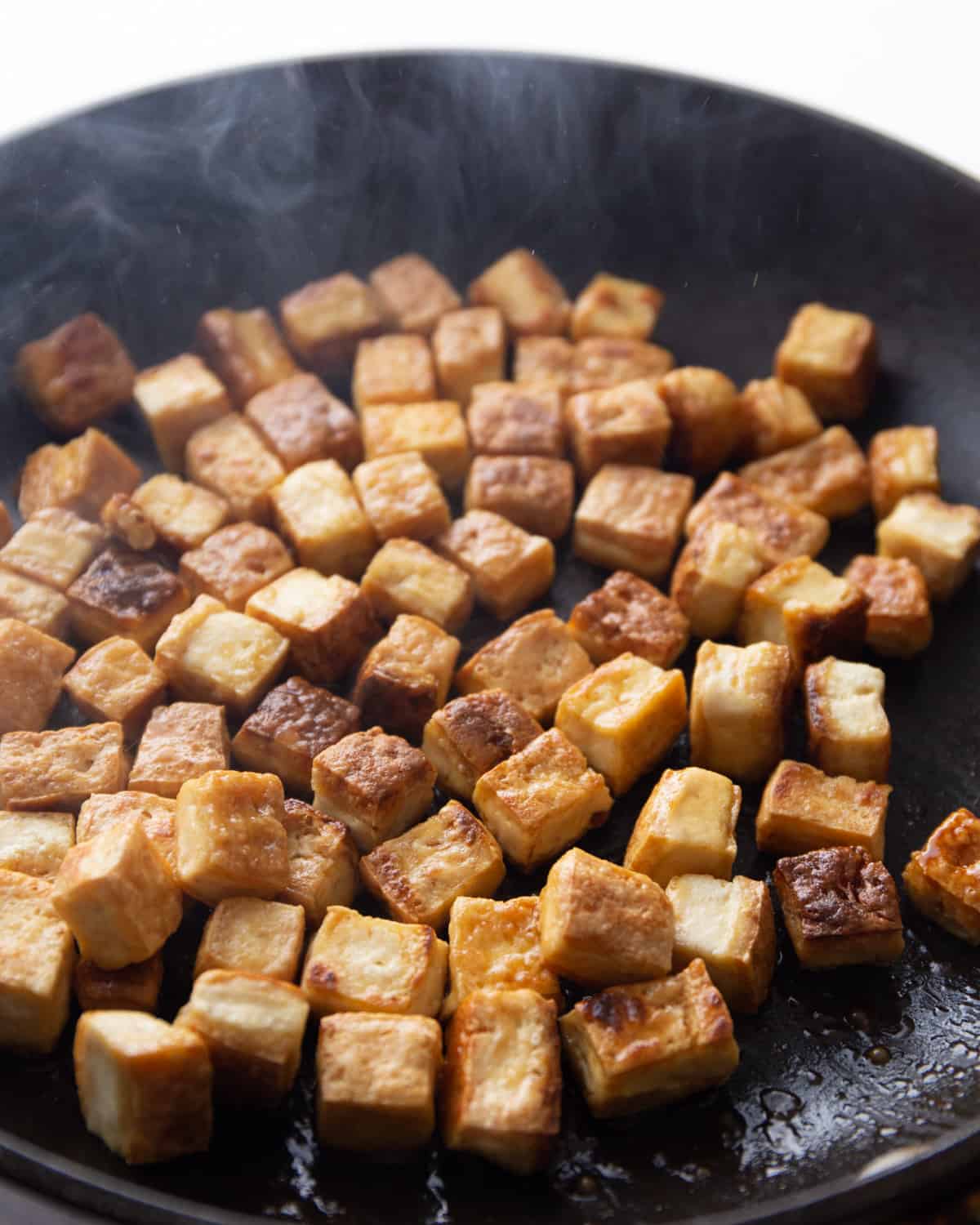 crispy tofu in a cast iron skillet